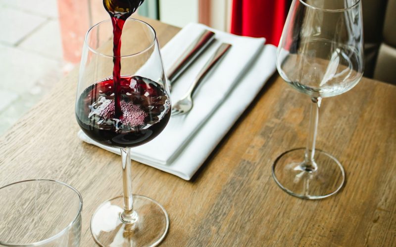 italian red wine being poured into a glass