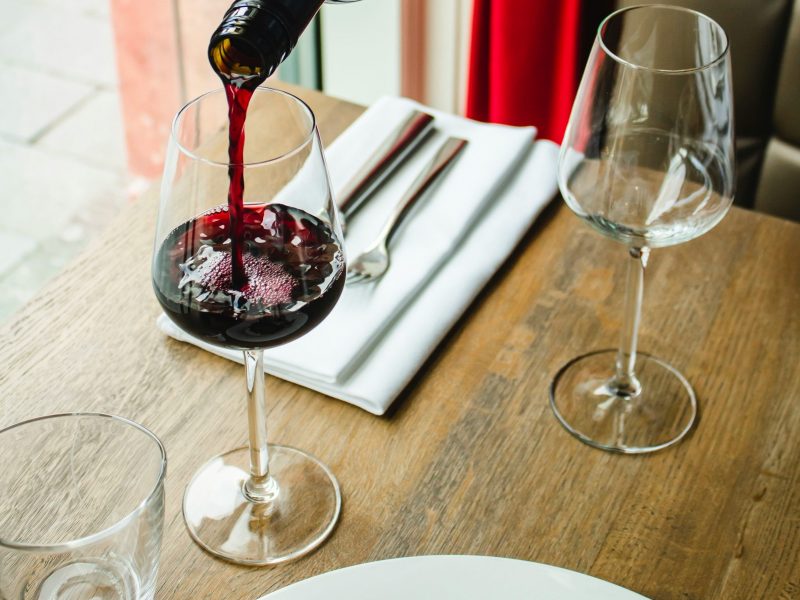 italian red wine being poured into a glass